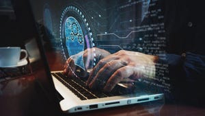 worker typing on a keyboard with a robot head hovering over it