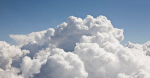 clouds below a blue sky