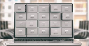stacked storage boxes on a computer
