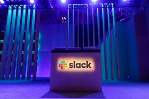 A Slack logo is illuminated on a conference stage at Slack Frontiers 2019