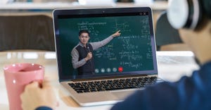 student learning with teacher on black board via video call conference