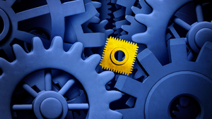 yellow block stuck in between blue cog wheels