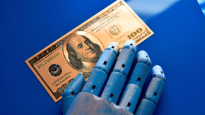 robot hand on one hundred dollar bill
