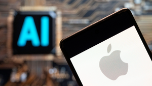 iPhone with Apple logo on screen held in front of AI background